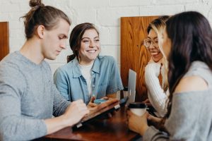 Students around a table, laughing