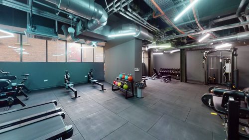 The Exchange Student Accommodation Liverpool - State of the art gym. The photo shows modern treadmills, bicycles, dumbbells, a bench, weight lifting equipment, etc. 